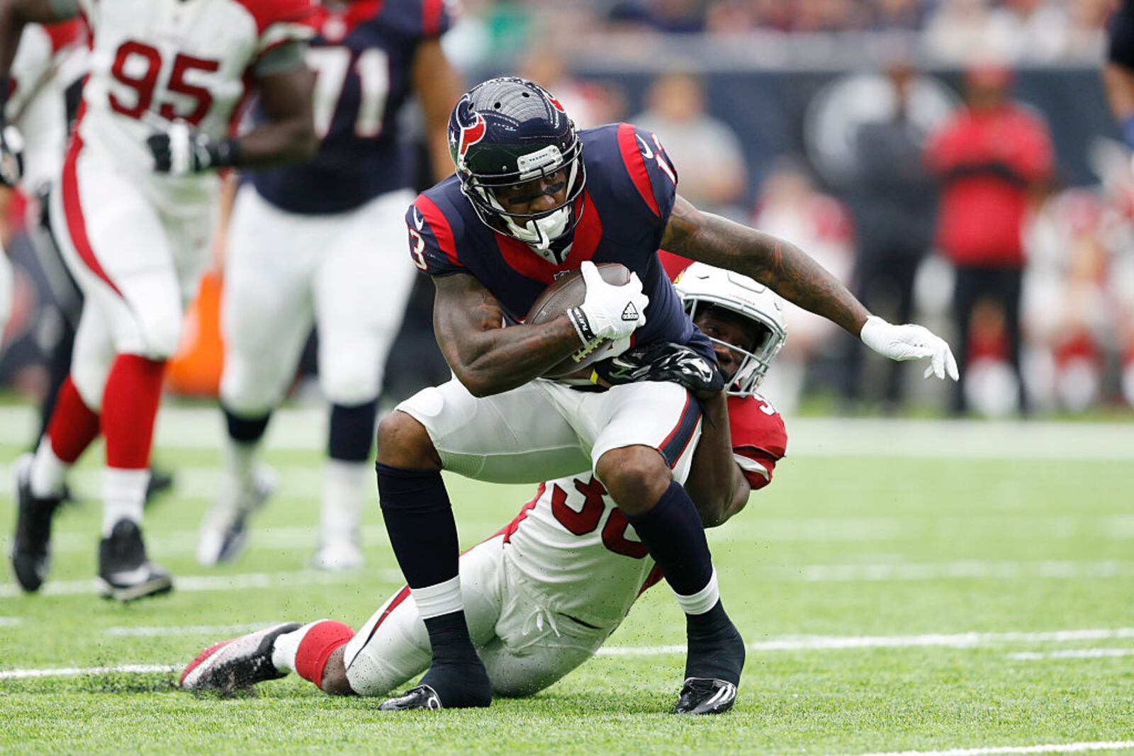 HOUSTON, TX - AUGUST 28: Braxton Miller #13 of the Houston Texans is tackled by Ronald Zamort #38 of the Arizona Cardinals after a reception in the second quarter of a preseason NFL game at NRG Stadium on August 28, 2016 in Houston, Texas. (Photo by Joe Robbins/Getty Images)