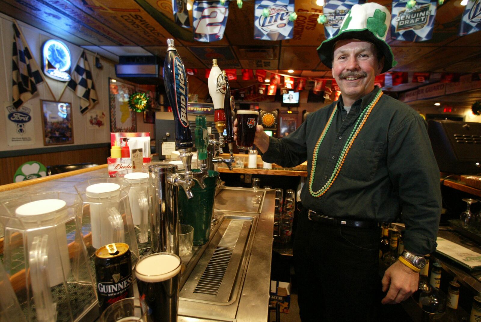 3/7/05  Stever Butterfield, proprietor of O'Leary's Pub and Grub, demonstrates proper pouring technique for beer. There will be plenty of beer available at his pub on St. Patrick's Day -- green and otherwise -- as well as Irish stew, Reuben sandwiches and karoke. PHOTO BY JAN UNDERWOOD