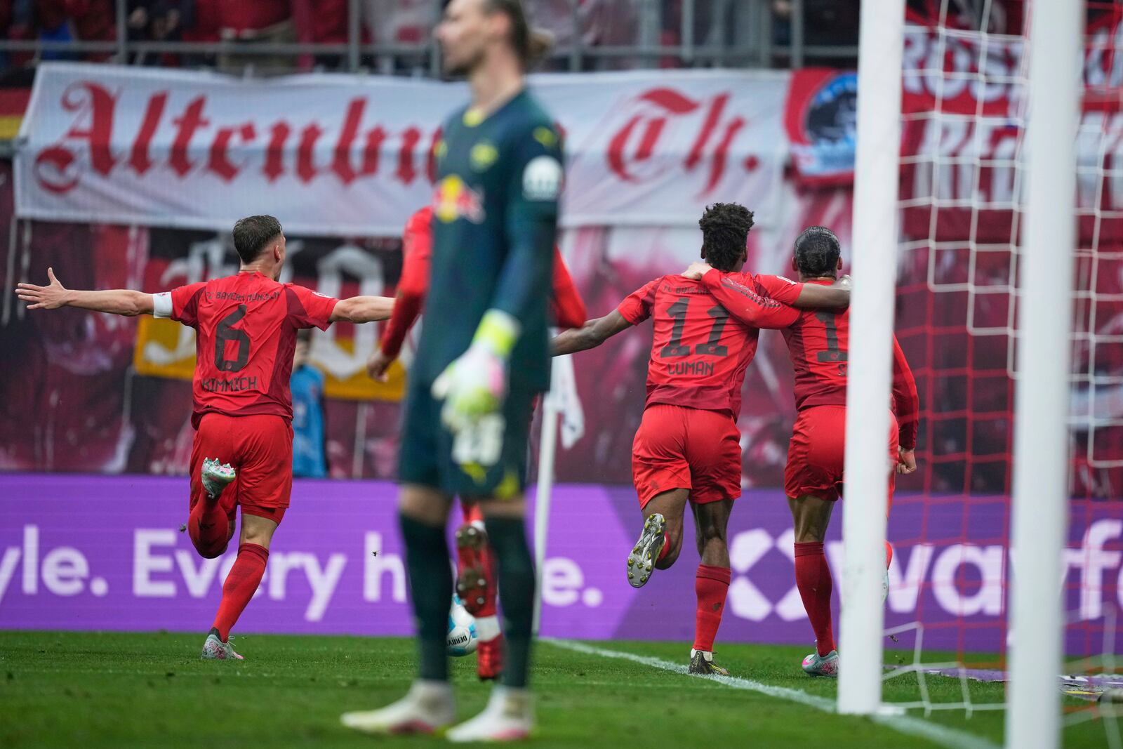 Bayern's Leroy Sane, right, celebrates with teammates after scoring his side's third goal during the German Bundesliga soccer match between RB Leipzig and FC Bayern Munich at the Red Bull Arena in Leipzig, Germany, Saturday, May 3, 2025. (AP Photo/Ebrahim Noroozi)