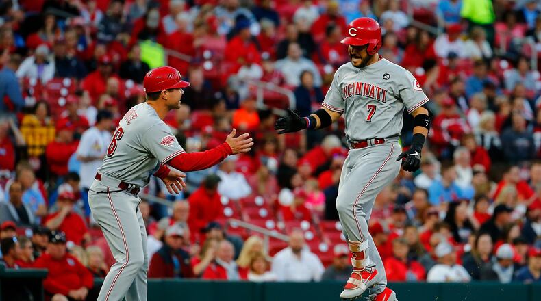 ST. LOUIS, MO - APRIL 26: Eugenio Suarez #7 of the Cincinnati Reds is congratulated by coach J.R. House #56 of the Cincinnati Reds after hitting a home run against the St. Louis Cardinals in the first inning at Busch Stadium on April 26, 2019 in St. Louis, Missouri. (Photo by Dilip Vishwanat/Getty Images)