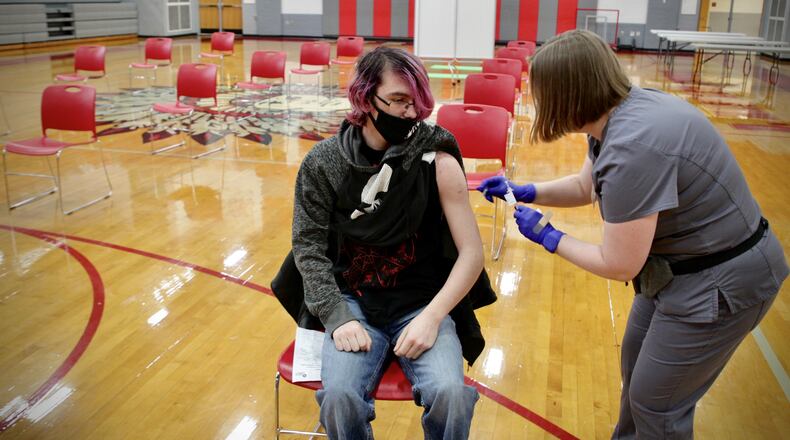 Stebbins High School sophomore, Ryan Riesenbeck gets a COVID-19 shot by Sinclair College nursing student Sarah Mills Wednesday April 28, 2021.
waits for 15 minutes after he received a COVID-19 vaccination at the school Wednesday April 28, 2021. JIM NOELKER/STAFF