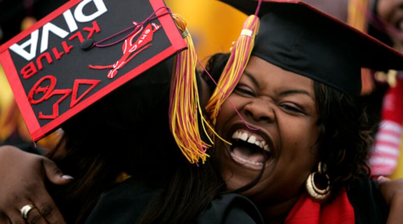 A Central State University graduate gets a hug from a fellow student at the commencement ceremony held at the university Saturday, May 3, 2008.