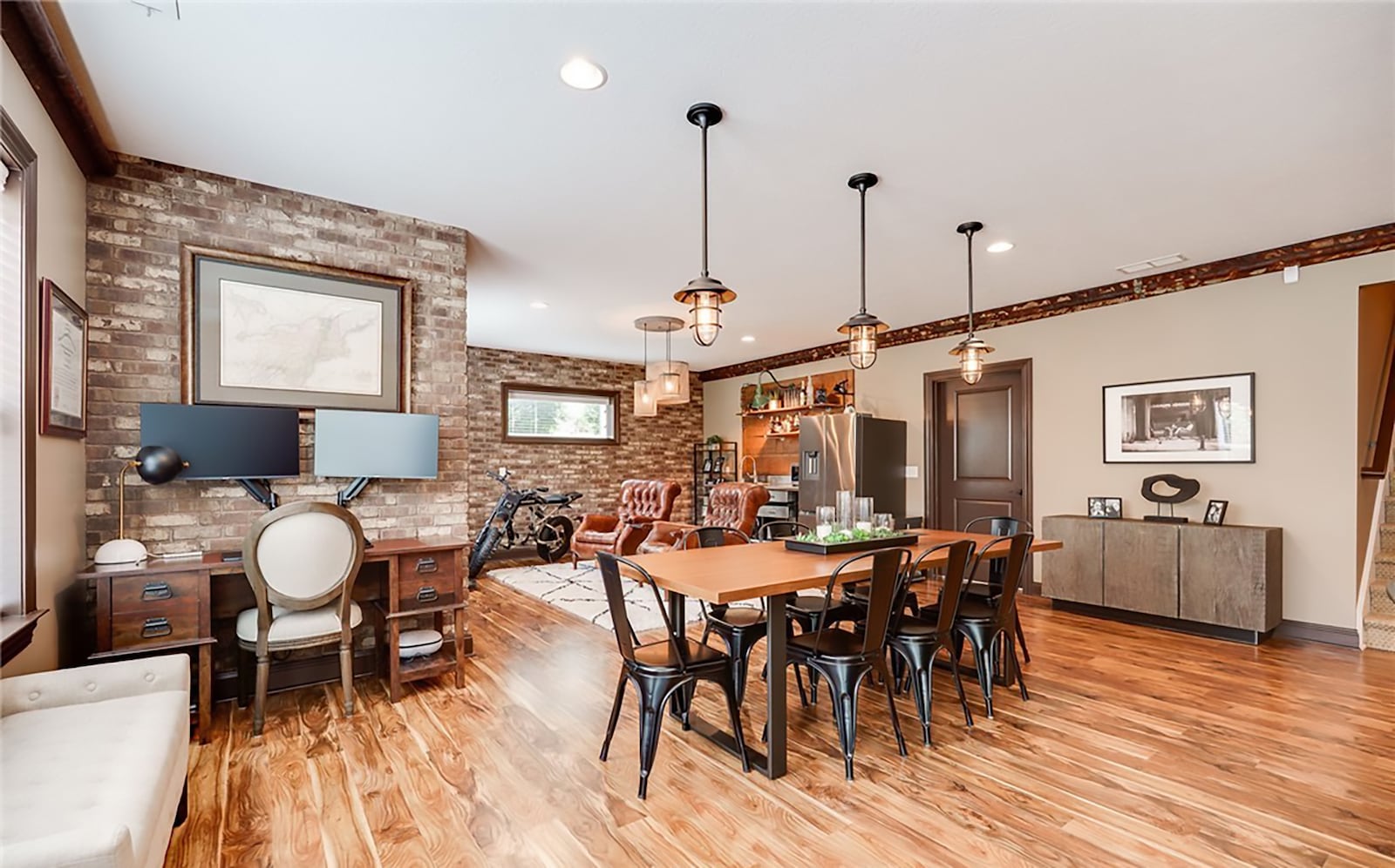 The finished basement features a recreation room with hardwood floors, a gas fireplace and a wet bar with a stainless steel counter, sink and full size refrigerator. CONTRIBUTED
