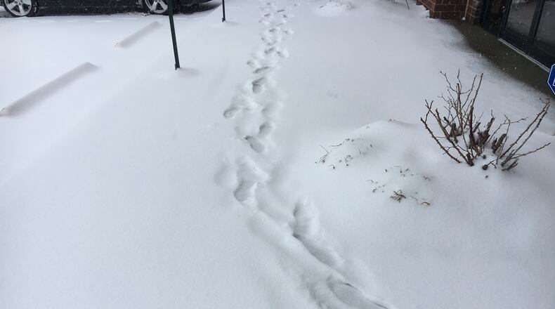 The snow is beginning to pile up, and Cincinnati Dayton Road in Liberty Twp. was treacherous Saturday morning. STAFF