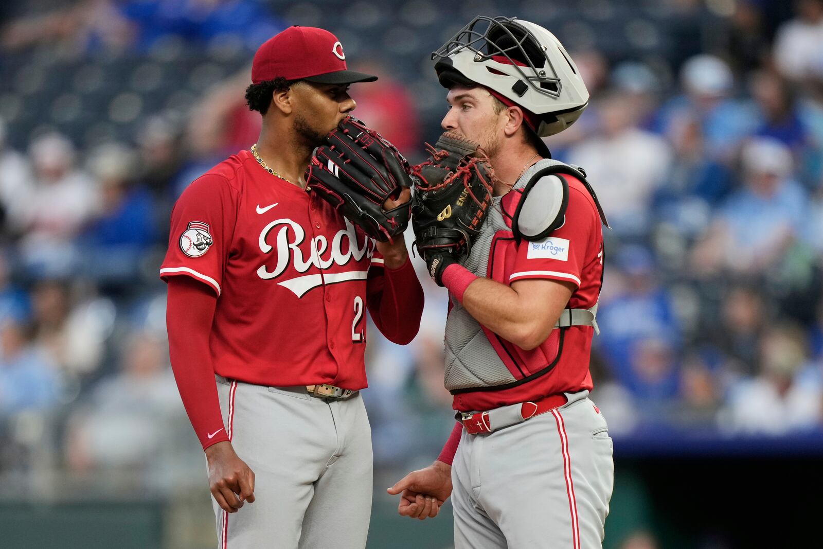 Cincinnati Reds starting pitcher Hunter Greene and catcher Tyler Stephenson meet on the mound during the fourth inning of a baseball game against the Kansas City Royals, Wednesday, May 28, 2025, in Kansas City, Mo. (AP Photo/Charlie Riedel)