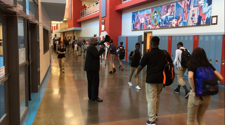Belmont High School Principal Donetrus Hill uses a bullhorn to urge students to get to class on time during his first month at the school in August 2018. JEREMY P. KELLEY / STAFF