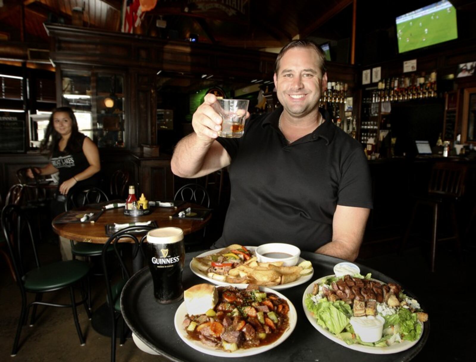 Steve Tieber, co-owner of the Dublin Pub. Pictured are three entrees: (clockwise from front) Guiness Beef Stew, the Black and Bleu Salad, and the Irish Dip sandwich with fries. STAFF/FILE