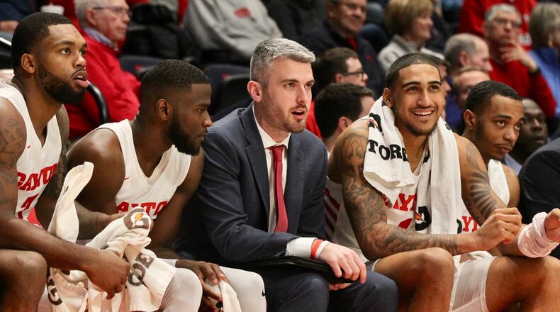 Dayton's Obi Toppin, second from right, sits on the bench during an exhibition game against Cedarville on Saturday, Nov. 2, 2019 at UD Arena. Also pictured are (left to right): Trey Landers, Jalen Crutcher, Brett Comer and, far right, Rodney Chatman.