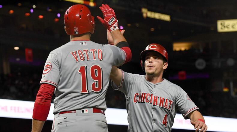 SAN FRANCISCO, CA - MAY 11: Scooter Gennett #4 of the Cincinnati Reds is congratulated by Joey Votto #19 after Gennett scored against the San Francisco Giants in the top of the eighth inning at AT&T Park on May 11, 2017 in San Francisco, California. (Photo by Thearon W. Henderson/Getty Images)