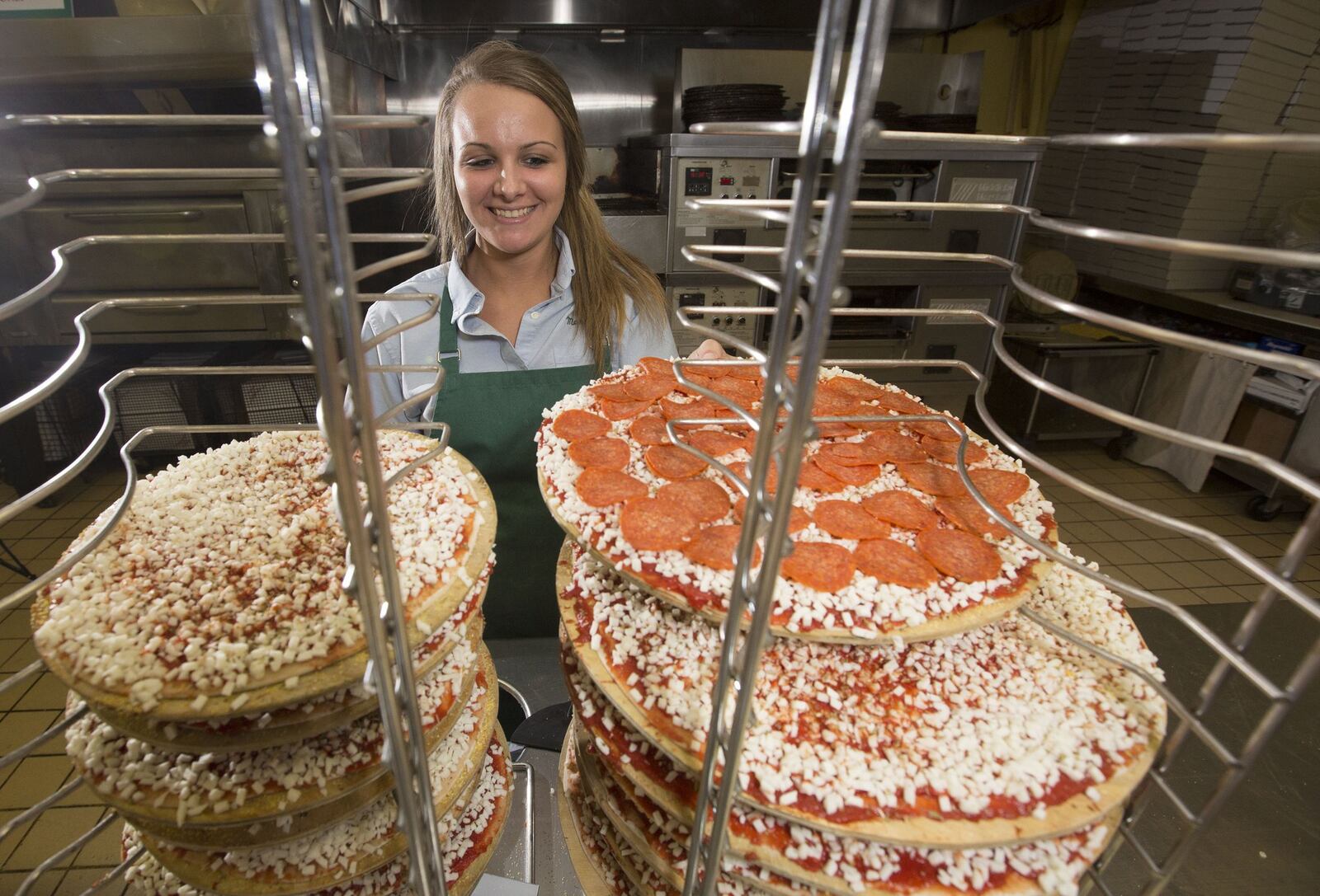 Candice Miller makes pizzas at Marion’s in the Shroyer Rd. location. Marion’s and Cassano’s are two local pizza giants who have held their ground in the ever-changing pizza landscape in Dayton.
