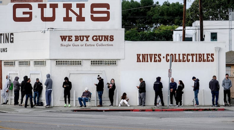 FILE - People wait to enter a gun store in Culver City, Calif., March 15, 2020. (AP Photo/Ringo H.W. Chiu, File)
