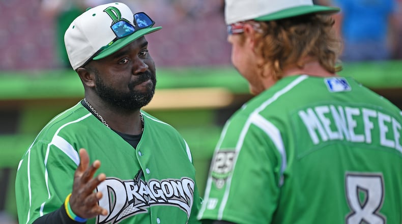 Dragons manager Vince Harrison Jr. and pitcher Joseph Menefee celebrate winning the season finale on Sunday at Day Air Ballpark. JEFF GILBERT/CONTRIBUTED