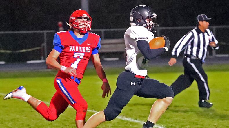 Graham's Jayden Sells rushes for a touchdown after catching a pass under pressure from Northwestern's Nathan Dewey. BILL LACKEY/STAFF