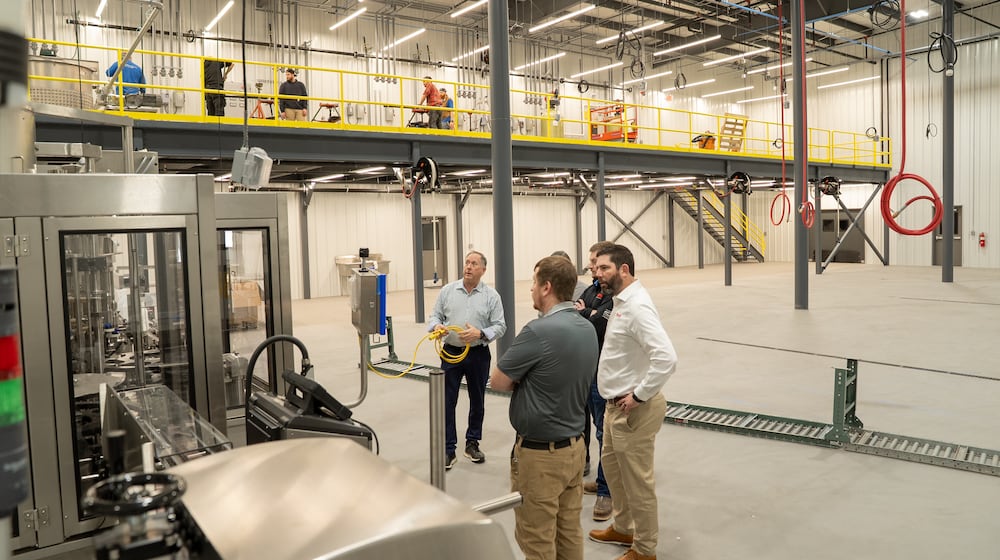 Bruns General Contracting and Belton Foods teams review Belton Foods' new $8 million, 73,750-square-foot facility recently completed by Bruns General Contracting at the Englewood Otterbein Industrial Park. CONTRIBUTED