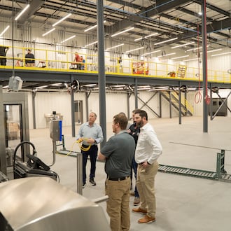 Bruns General Contracting and Belton Foods teams review Belton Foods' new $8 million, 73,750-square-foot facility recently completed by Bruns General Contracting at the Englewood Otterbein Industrial Park. CONTRIBUTED