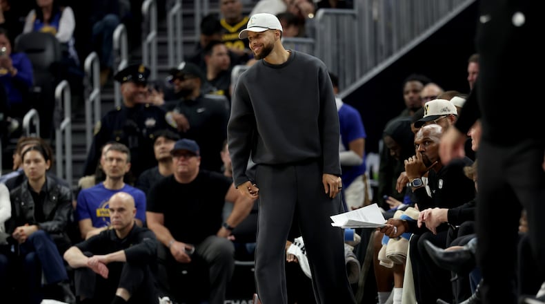 Golden State Warriors guard Stephen Curry stands at the bench during the first half of an NBA basketball game against the Memphis Grizzlies in San Francisco, Monday, Feb. 9, 2026. (AP Photo/Jed Jacobsohn)