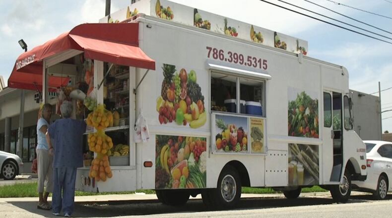 A bodega truck sits outside a shopping plaza where people can shop for produce and other cooking essentials on June 20, 2018 in Miami. (Daniel A. Varela/Miami Herald/TNS)