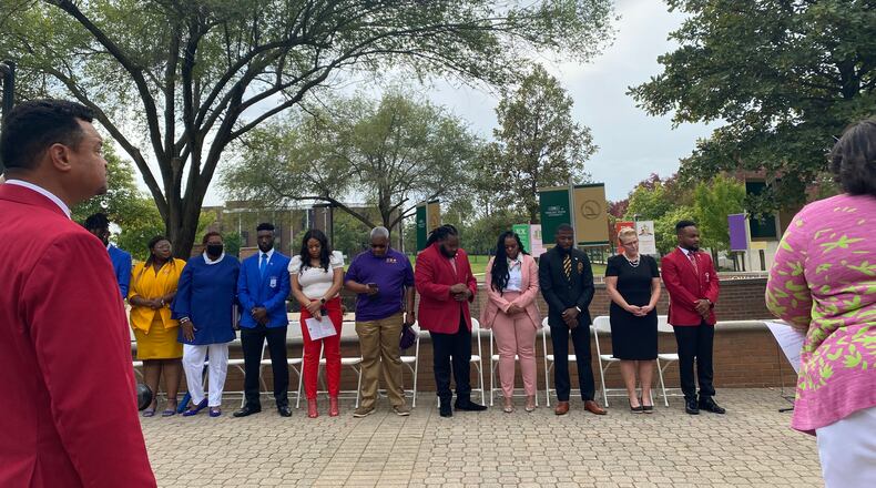 NPHC members and university administration stand as an innovation is read on Saturday to introduce the National Pan-Hellenic Council Memorial Plots to campus. Eileen McClory / Staff