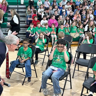 Gov. Mike DeWine and First Lady Fran check on some kindergarten and first-grade New Miami students who received free glasses Thursday afternoon as part of the Ohio Student Eye Exam program. RICK McCRABB/CONTRIBUTOR