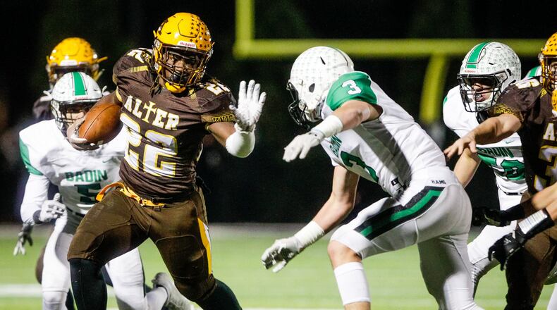 Alter’s Branden McDonald (22) tries to avoid a tackle by Badin’s Keegan Gormley during Friday night’s Division III, Region 12 playoff semifinal at Barnitz Stadium in Middletown. NICK GRAHAM/STAFF