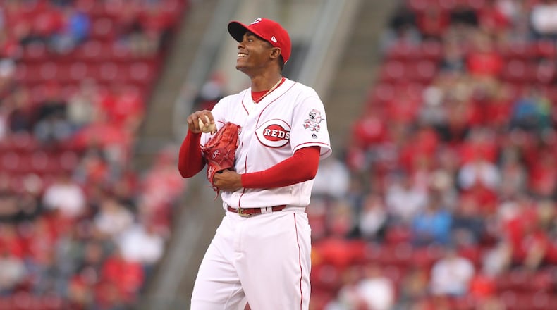 Reds reliever Raisel Iglesias smiles after walking a Phillies batter on Monday, April 3, 2017, at Great American Ball Park in Cincinnati. David Jablonski/Staff