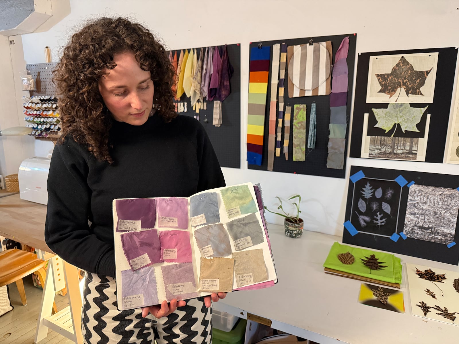 Jess LaCava holds a book containing fabric swatches she has made from DIY elderberry dye. She works in the apparel world of textile and graphics and is a mother of two young children. HANNAH KASPER/CONTRIBUTED