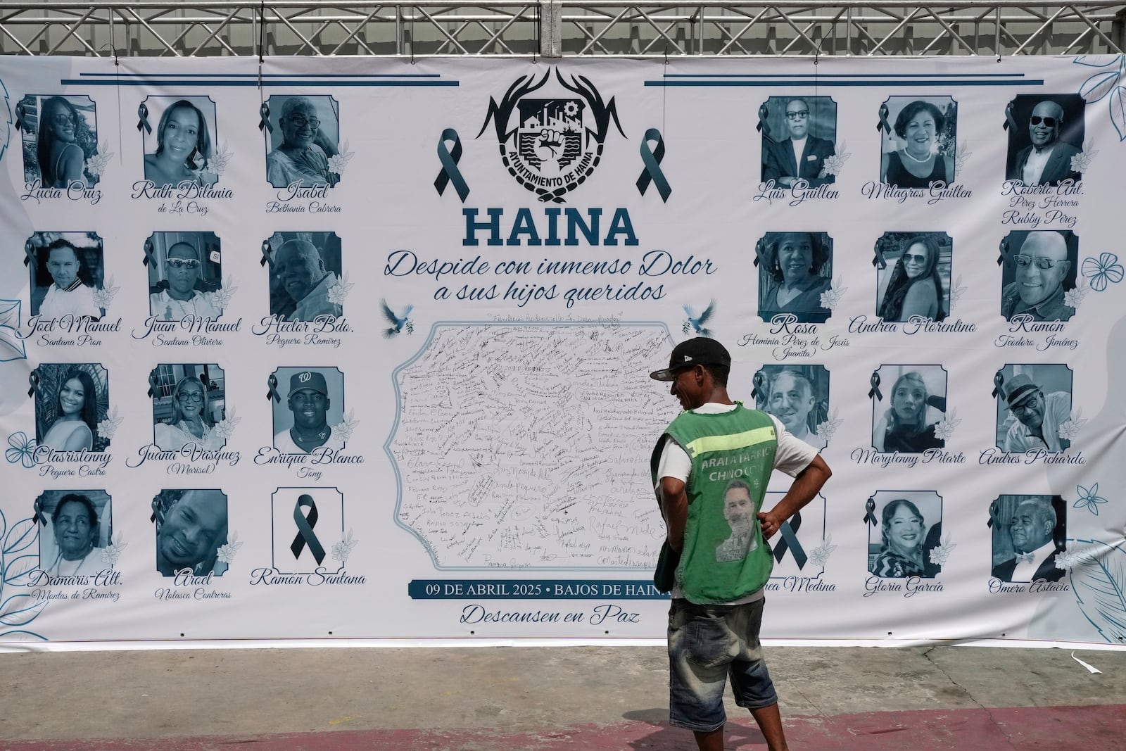 FILE - A banner with images of some of the victims of the Jet Set nightclub roof collapse that killed more than 200 people, is displayed on a facade in Haina, Dominican Republic, April 10, 2025. (AP Photo/Matias Delacroix, File)
