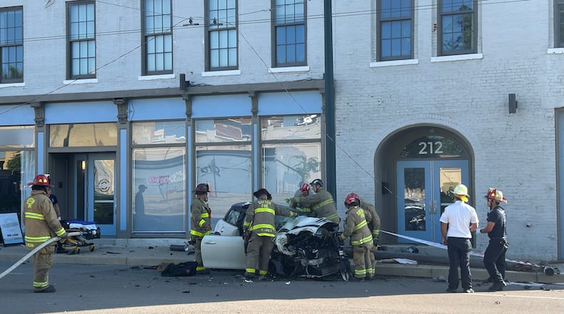 A car hit a pole on Wayne Avenue near Jackson and East Fourth streets in downtown Dayton Monday, Aug. 18, 2025. STAFF PHOTO