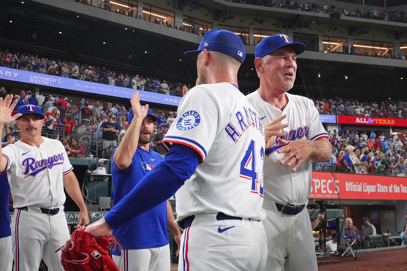 Texas Rangers manager Bruce Bochy, right, congratulates closing pitcher Shawn Armstrong (43) after a baseball game against the Houston Astros, Thursday, May 15, 2025, in Arlington, Texas. (AP Photo/LM Otero)