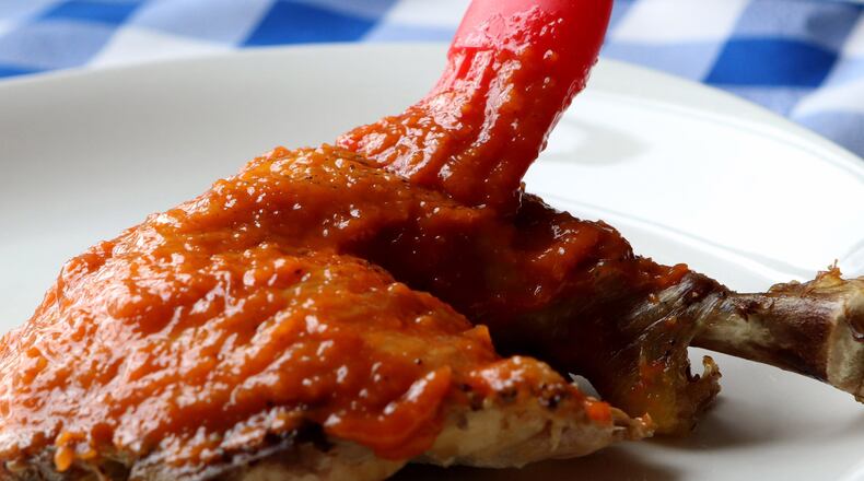 Homemade apple-bourbon barbecue sauce served on chicken. (Hillary Levin/St. Louis Post-Dispatch/TNS)