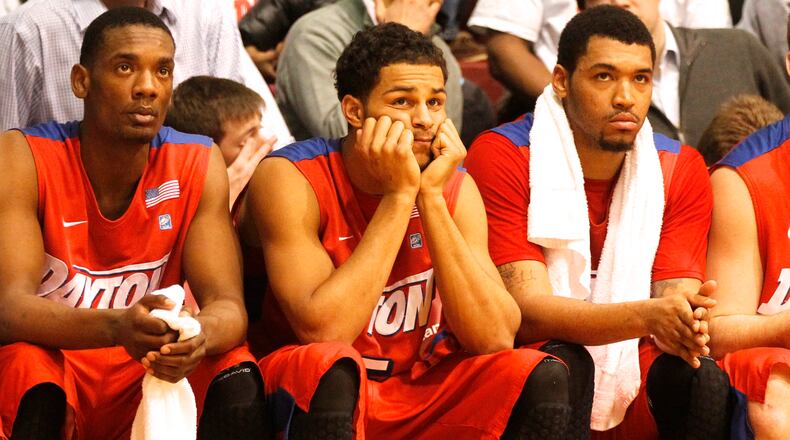 Dayton's Dyshawn Pierre, left, Devin Oliver and Jalen Robinson watch the final seconds tick away in a loss to Saint Joseph's on Tuesday, Feb. 25, 2014, at Hagan Arena in Philadelphia. David Jablonski/Staff