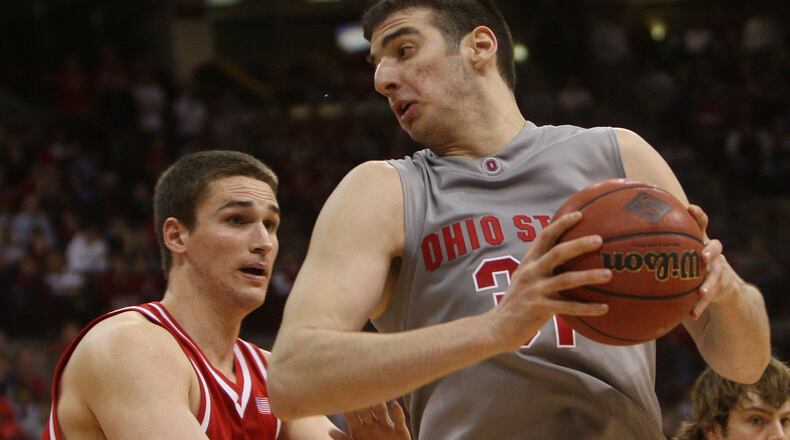 Ohio State's Kosta Koufos, right, turns to go to the basket as Dayton's Kurt Huelsman, left, defends in the second half of the quarterfinal round of the National Invitational Tournament basketball game Wednesday, March 26, 2008, at Value City Arena, in Columbus, Ohio. (AP Photo/Terry Gilliam)
