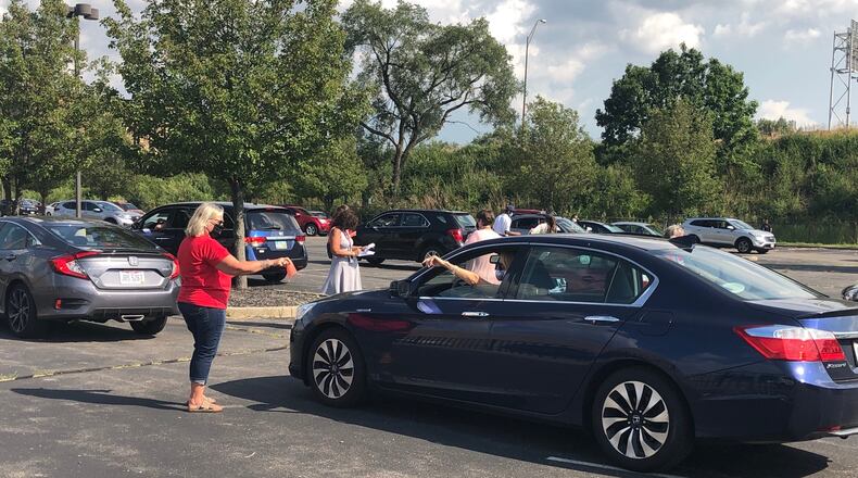 Hundreds of Dayton teachers union members participated in a drive-thru vote  Monday, Aug. 24, 2020, at Ponitz Career Technology Center that is connected to Dayton Public Schools' upcoming layoffs plan.