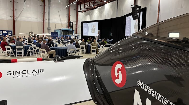 With a Sinclair Community College-owned BlackFly eVTOL (electric vertical takeoff and landing) aircraft in the foreground, the first day of the 2025 National Advanced Air Mobility Industry Forum was Tuesday, Oct. 14, 2025 at Springfield-Beckley Municipal Airport. THOMAS GNAU/STAFF