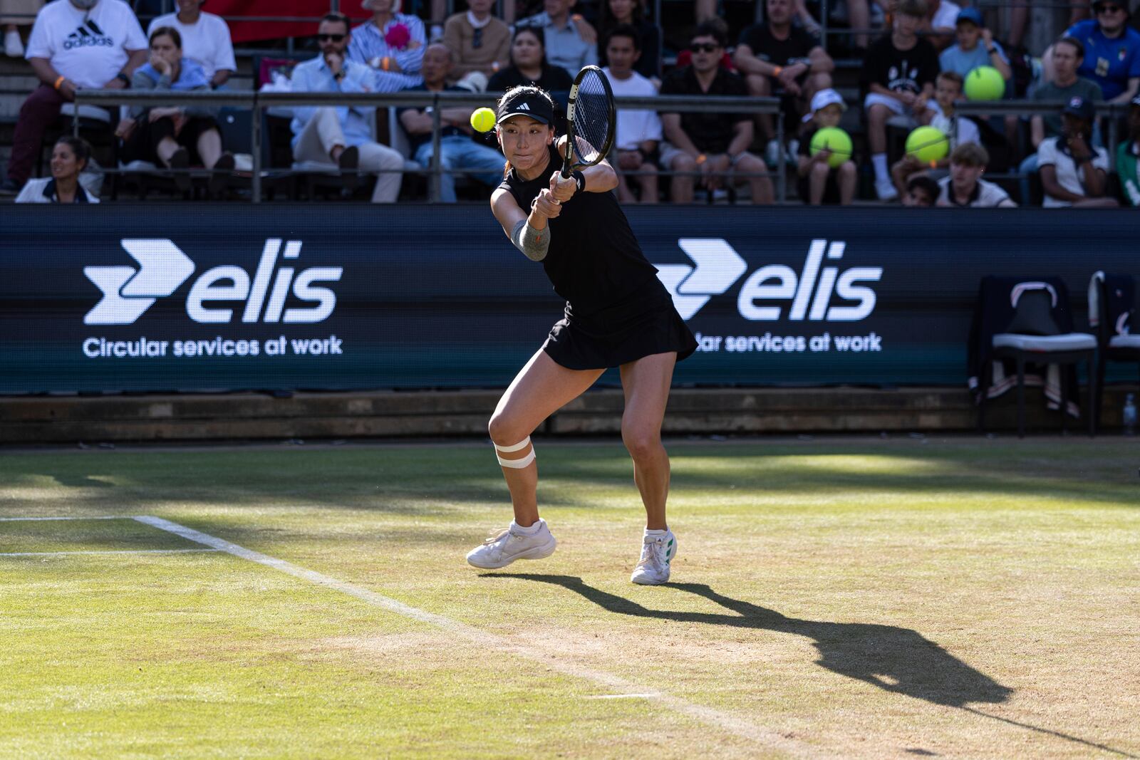 China's Xinyu Wang plays a return to Coco Gauff of the United States during the Berlin WTA tennis tournament in Berlin, Germany, Thursday, June 19, 2025. (Hannes P. Albert/dpa via AP)