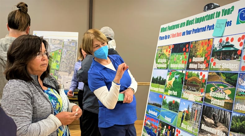 Beavercreek residents review and vote on potential amenities for the city's newest 148-acre park at a public open house Wednesday evening. LONDON BISHOP/STAFF