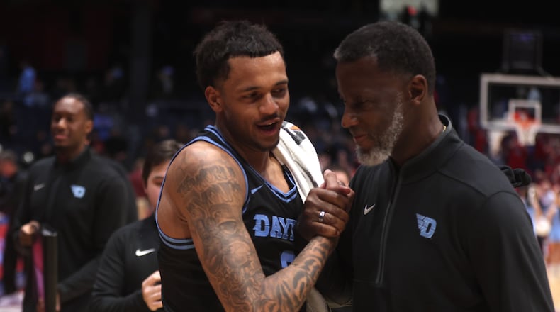Dayton's De'Shayne Montgomery, left, and Anthony Grant leave the court after a victory against Loyola Chicago on Friday, Jan. 16, 2026, at UD Arena. David Jablonski/Staff
