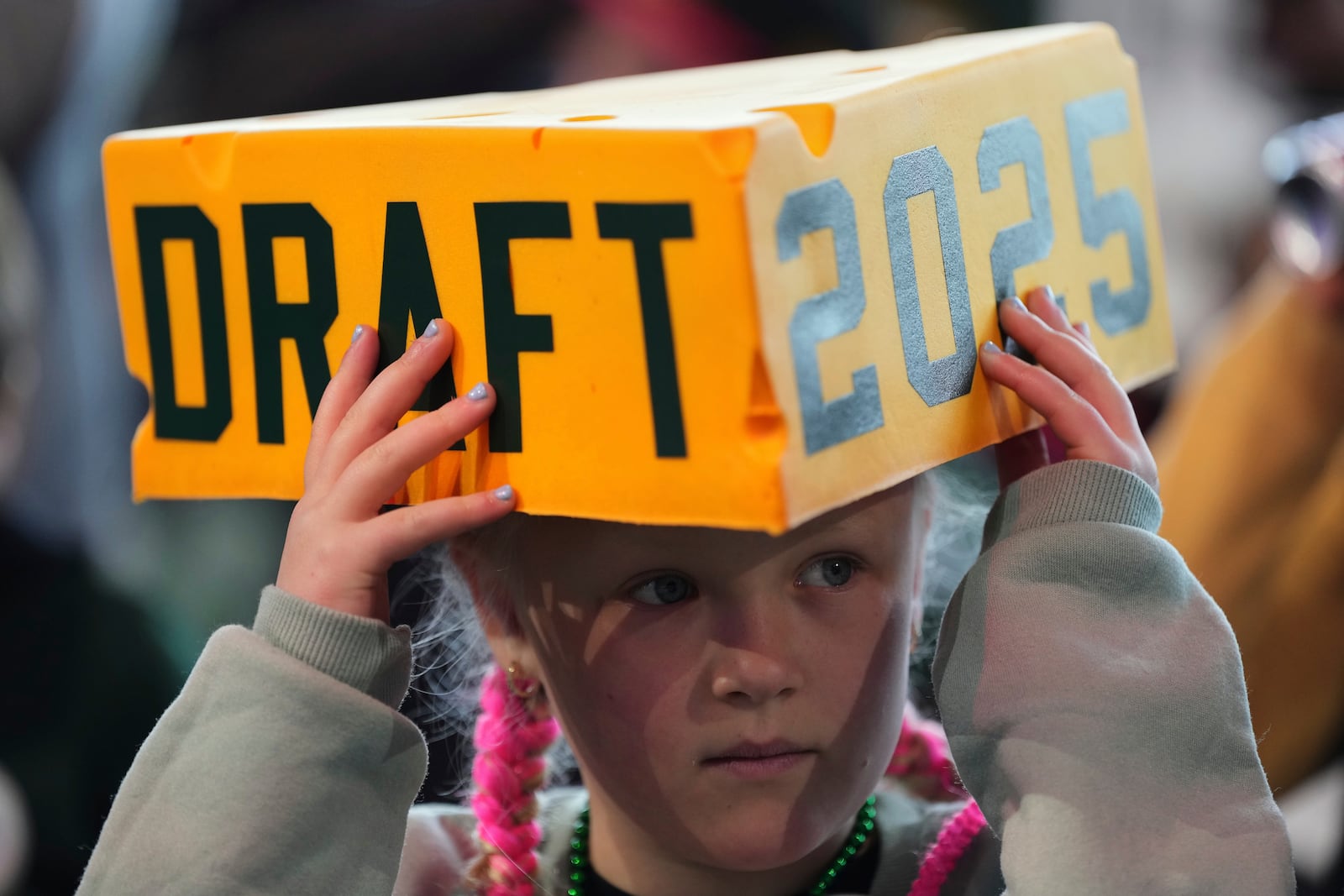A fan watches during the third day of the NFL football draft, Saturday, April 26, 2025, in Green Bay, Wis. (AP Photo/Jeff Roberson)