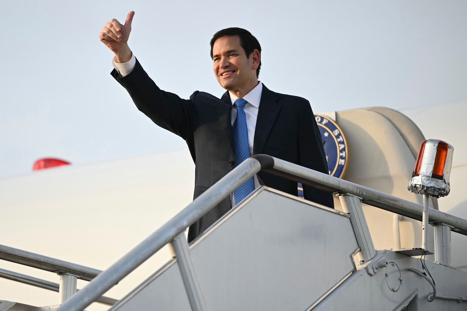 US Secretary of State Marco Rubio gestures as he boards his flight before departing from Subang Air Base, on the outskirts of Kuala Lumpur, on Friday, July 11, 2025, after attending the 58th ASEAN Foreign Ministers' meeting. (Mandel Ngan/Pool Photo via AP)