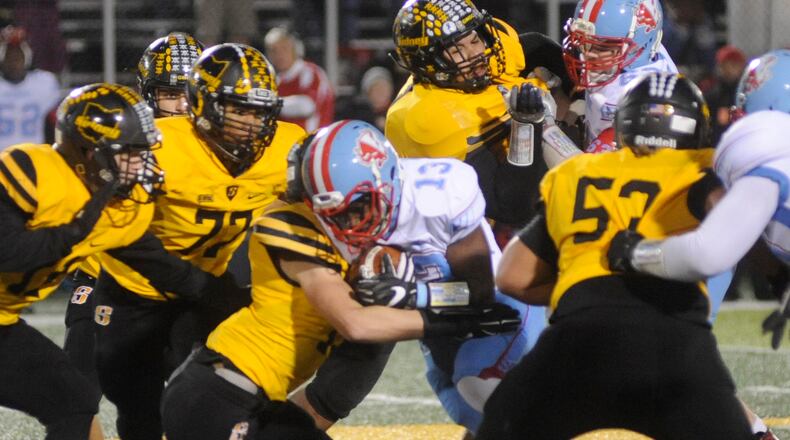 The Sidney defense, including Braydon Dean (77), passed a major challenge against Belmont running back Elijah Malcolm. MARC PENDLETON / STAFF