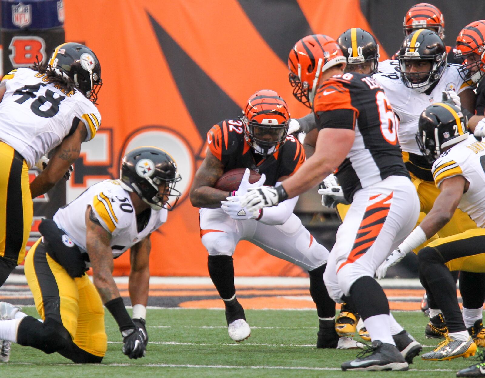 Bengals running back Jeremy Hill (32) runs up the middle during their game against the Steelers at Paul Brown Stadium, Sunday, Dec. 18, 2016. GREG LYNCH / STAFF