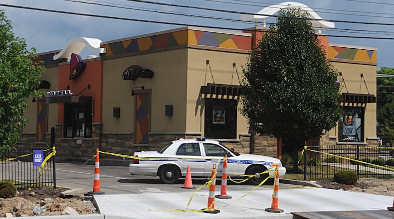 Taco Bell at 1414 N. Keowee St. is blocked off Thursday afternoon, Aug. 11, 2016, after someone dropped off a pizza box and claimed a bomb was inside. (Marshall Gorby/Staff)