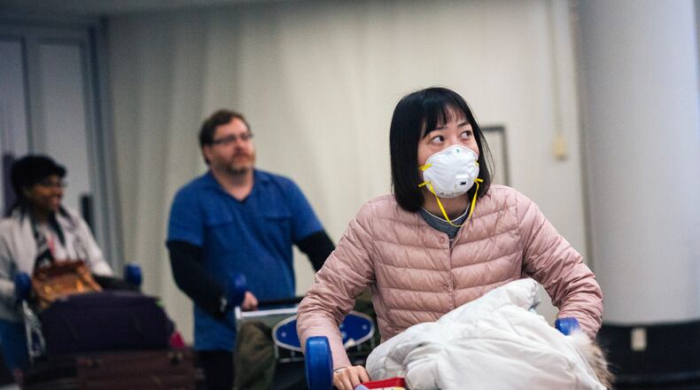 Travelers arrive at OHare International Airport in Chicago. Health officials around the country are struggling to keep up with costs of screening passengers from China and other parts of the world. (Taylor Glascock/The New York Times)