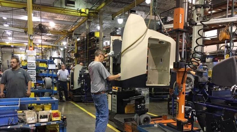 The chassis of a Crown vehicle is readied to be fitted over a power plant on a Crown assembly line in New Bremen in the summer of 2019. THOMAS GNAU/STAFF