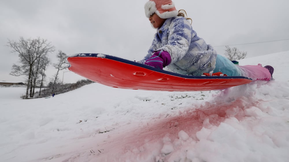 Luna Reed, 6, catches some air while sledding on a snow day off school Tuesday, Dec. 2, 2025 at St. John XXIII School in Middletown. NICK GRAHAM/STAFF