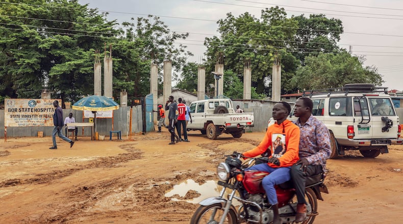 FILE - Motorists pass outside Bor State Hospital in Bor, South Sudan, Monday, Aug. 18, 2025. (AP Photo/Caitlin Kelly, File)