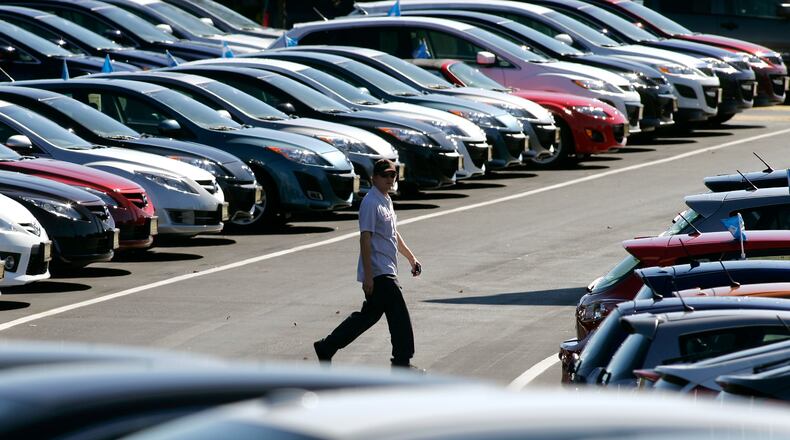A Mazda lot technician crossed the Castrucci Auto Mall lot in Miami Twp. in this 2010 file photo.