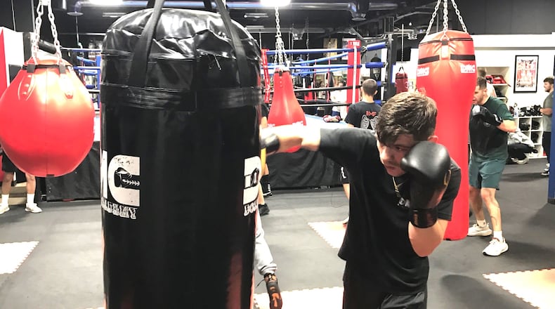 Liam Walsh works on the heavy bag during Monday night’s training session at the DMC Boxing Academy in Centerville. Tom Archdeacon/CONTRIBUTED