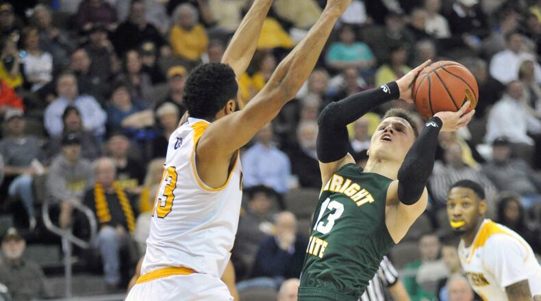Wright State junior guard Grant Benzinger puts up a shot against Northern Kentucky’s Brennan Gillis during Tuesday night’s game at the BB&T Arena. JAY MORRISON/STAFF PHOTO