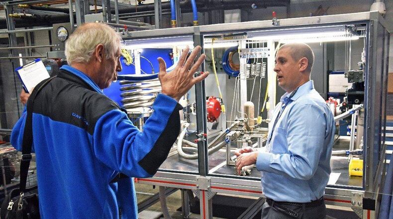 Marvin Gale (left), program manager for the Air Force Research Laboratory’s Maturation of Advanced Manufacturing for Low-cost Sustainment, or MAMLS, program, and Grady Marcum, AFRL chemical engineer, discuss the new heat exchange tester during the capability’s kick-off tour Nov. 6. (U.S. Air Force photos/Spencer Deer)